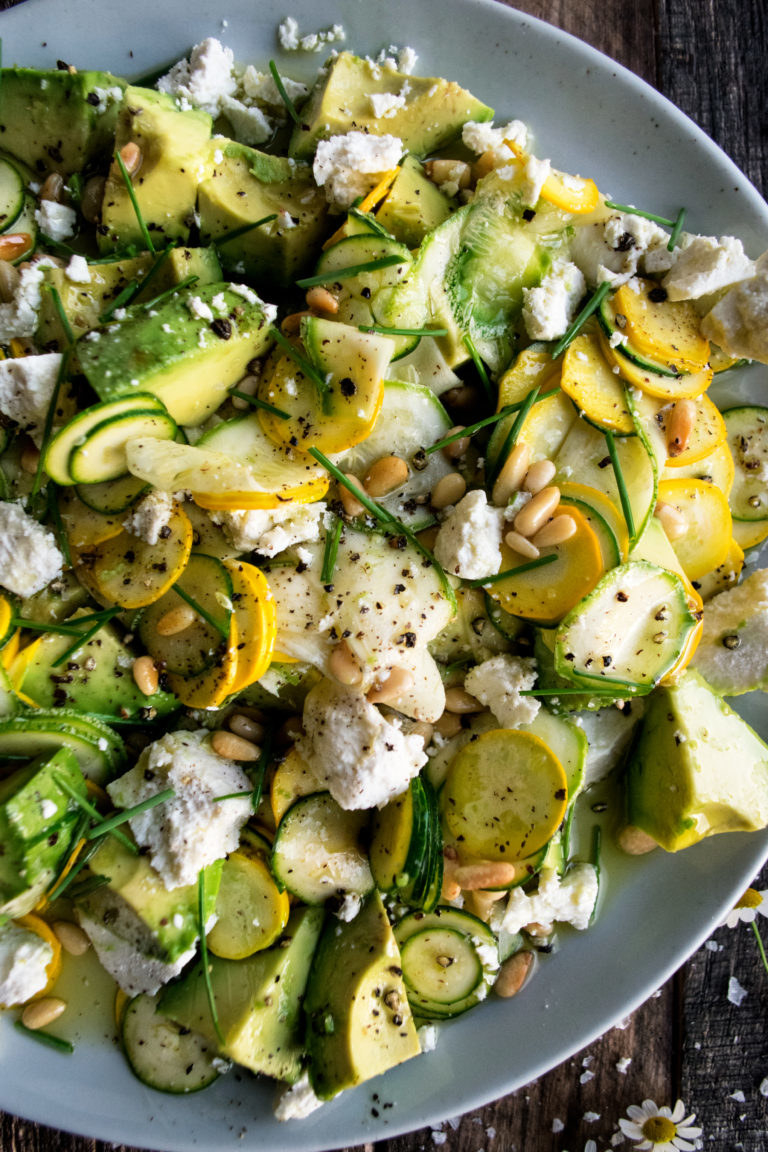 Summer squash salad with cheese, avocado, and nuts.