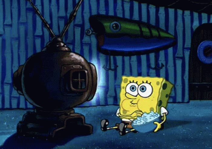 SpongeBob SquarePants sitting in front of a TV with a bowl of snacks