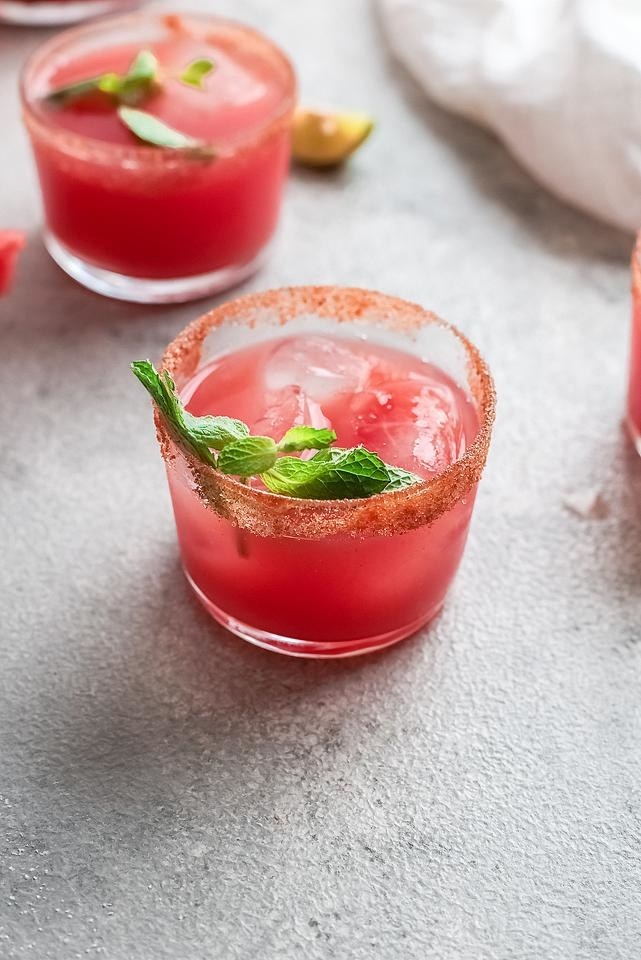 A watermelon paloma cocktail with a salted rim.