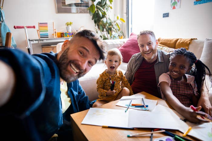 A family takes a selfie together while they draw in their home