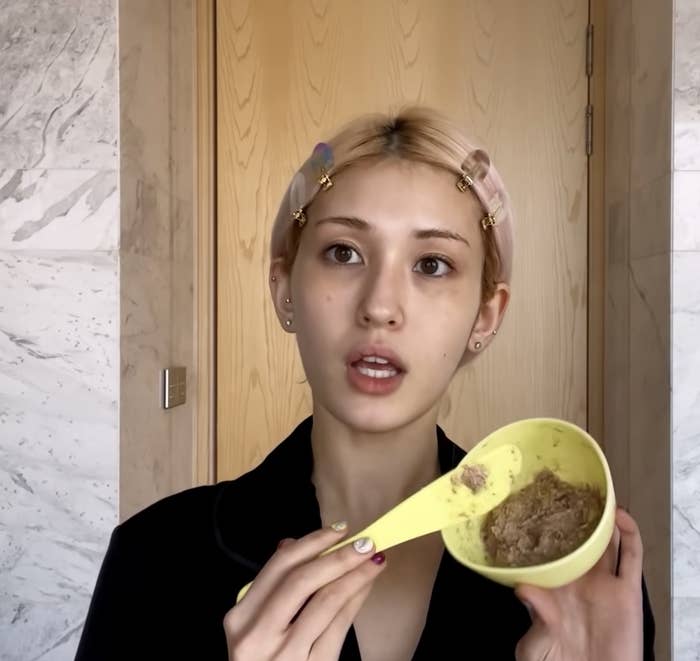 Jeon Somi holding a bowl of the mask ingredients