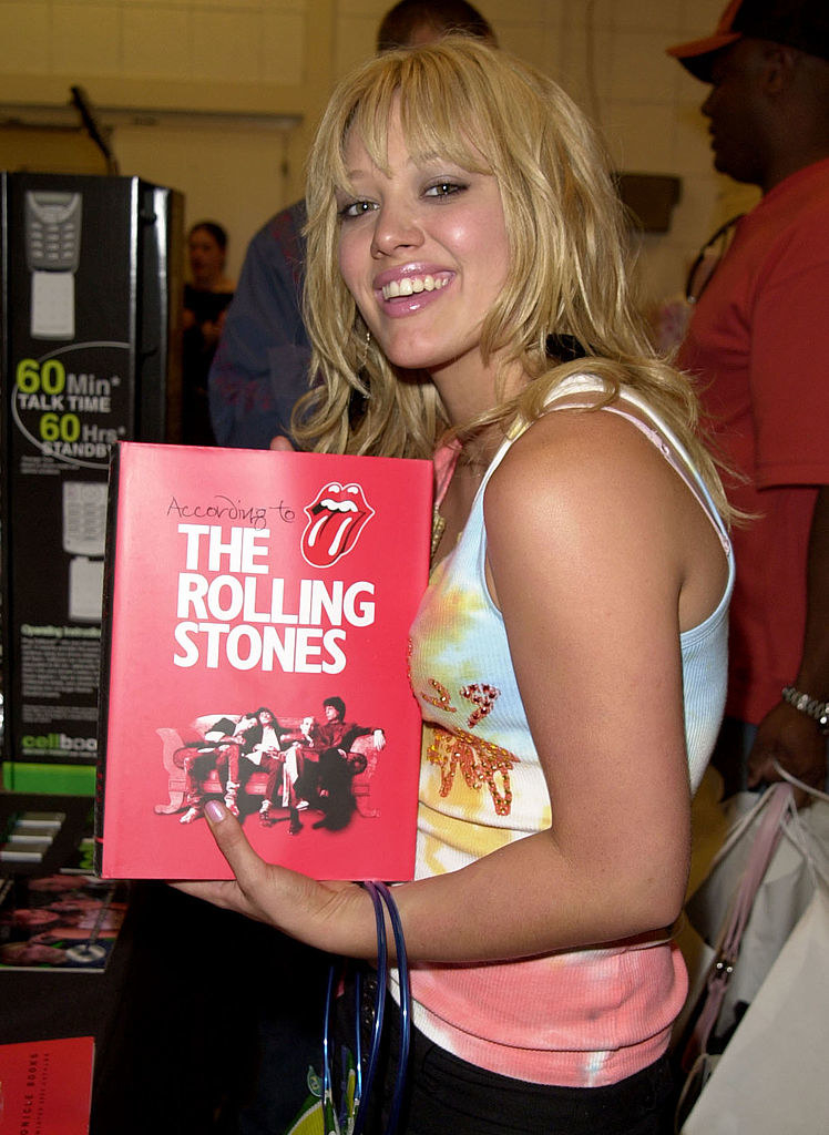 Hilary holding a book called &quot;According to the Rolling Stones&quot;