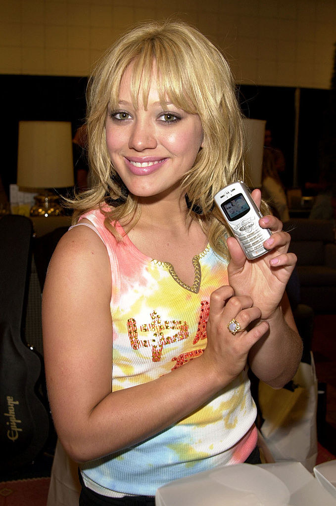 Hilary holding a small cellphone