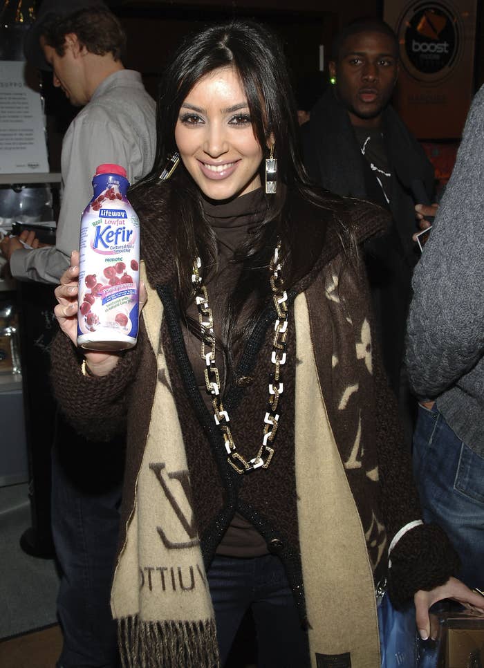 A young Kim holding a bottle of Kefir low-fat milk