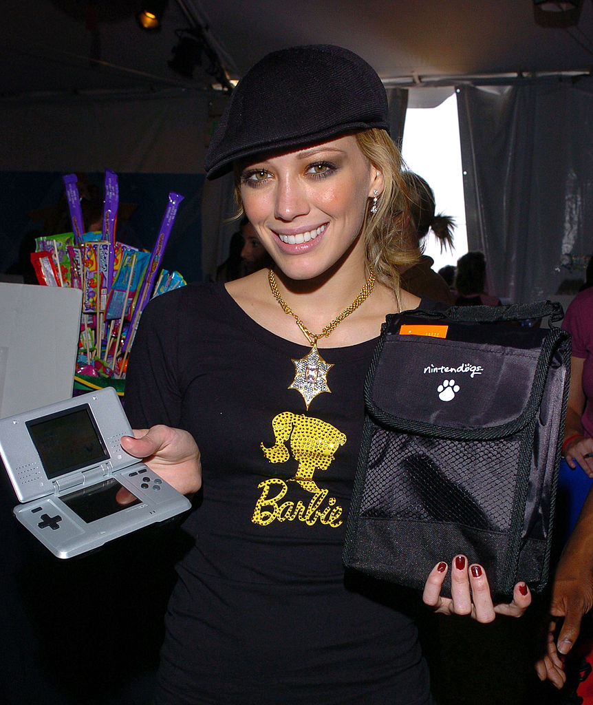 Hilary in a Barbie shirt and holding a Nintendo DS console with a &quot;Nintendogs&quot; bag