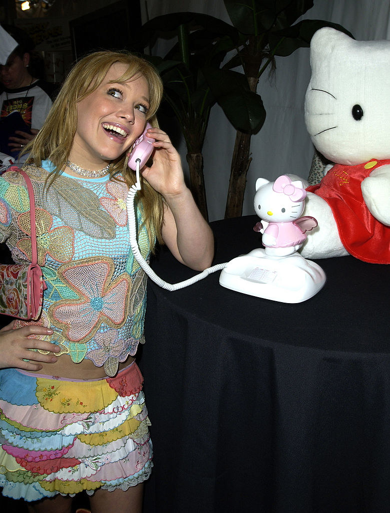 Hilary talking into a Hello Kitty corded phone