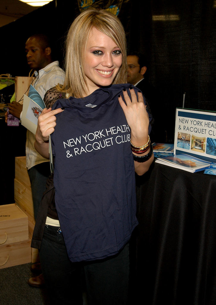 Hilary holding up a New York Health &amp;amp; Racquet Club T-shirt