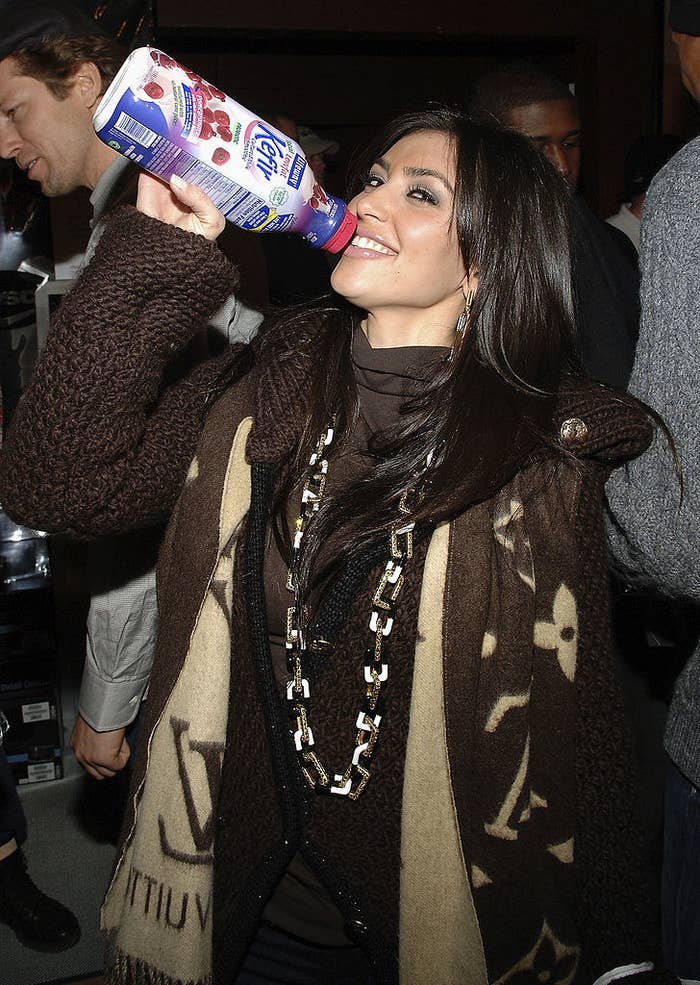 Kim pretending to drink from the Kefir bottle and smiling
