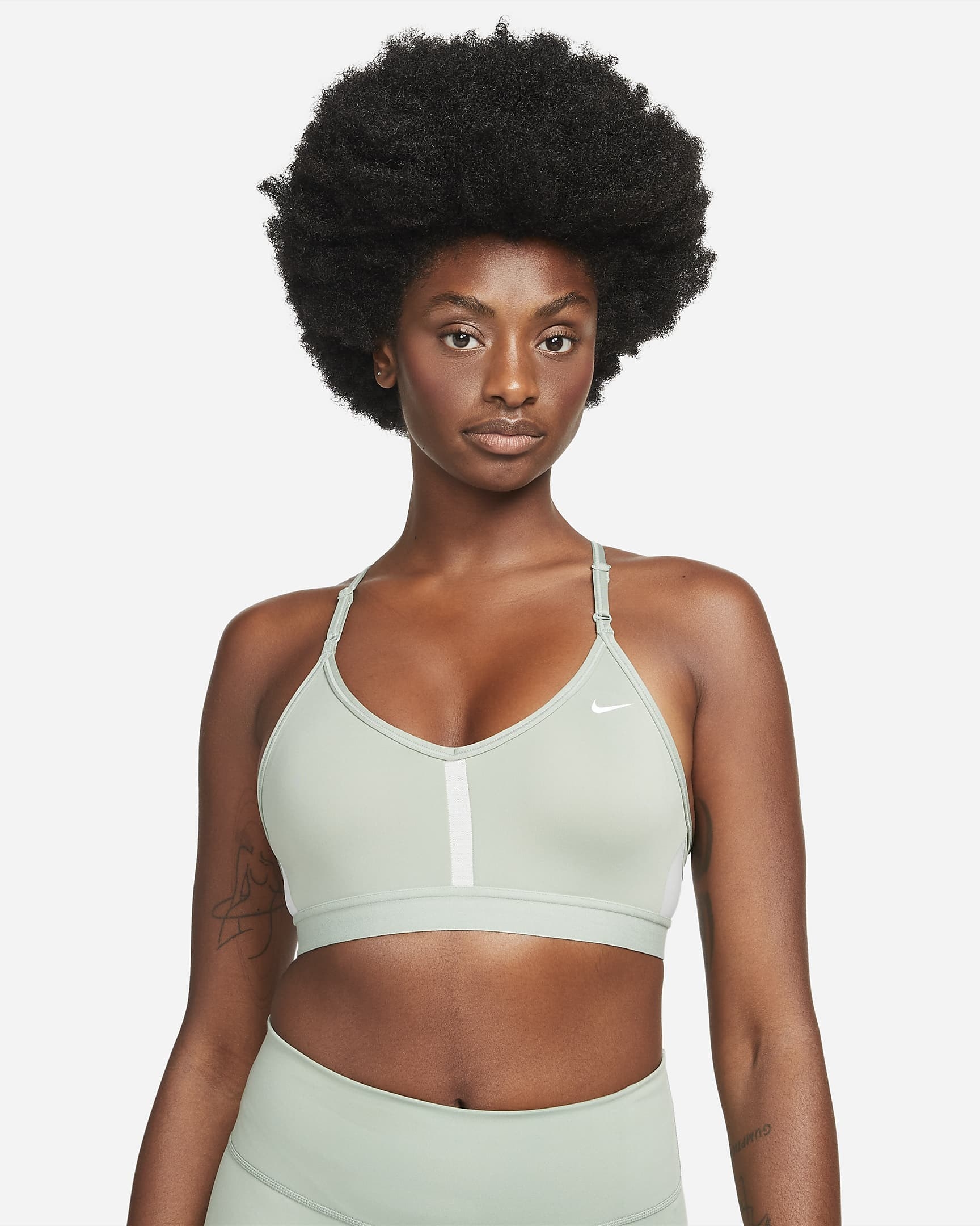 model in light sage green sports bra with thin straps