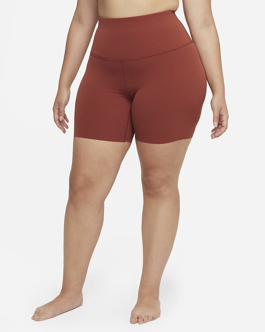 model in brick red bike shorts