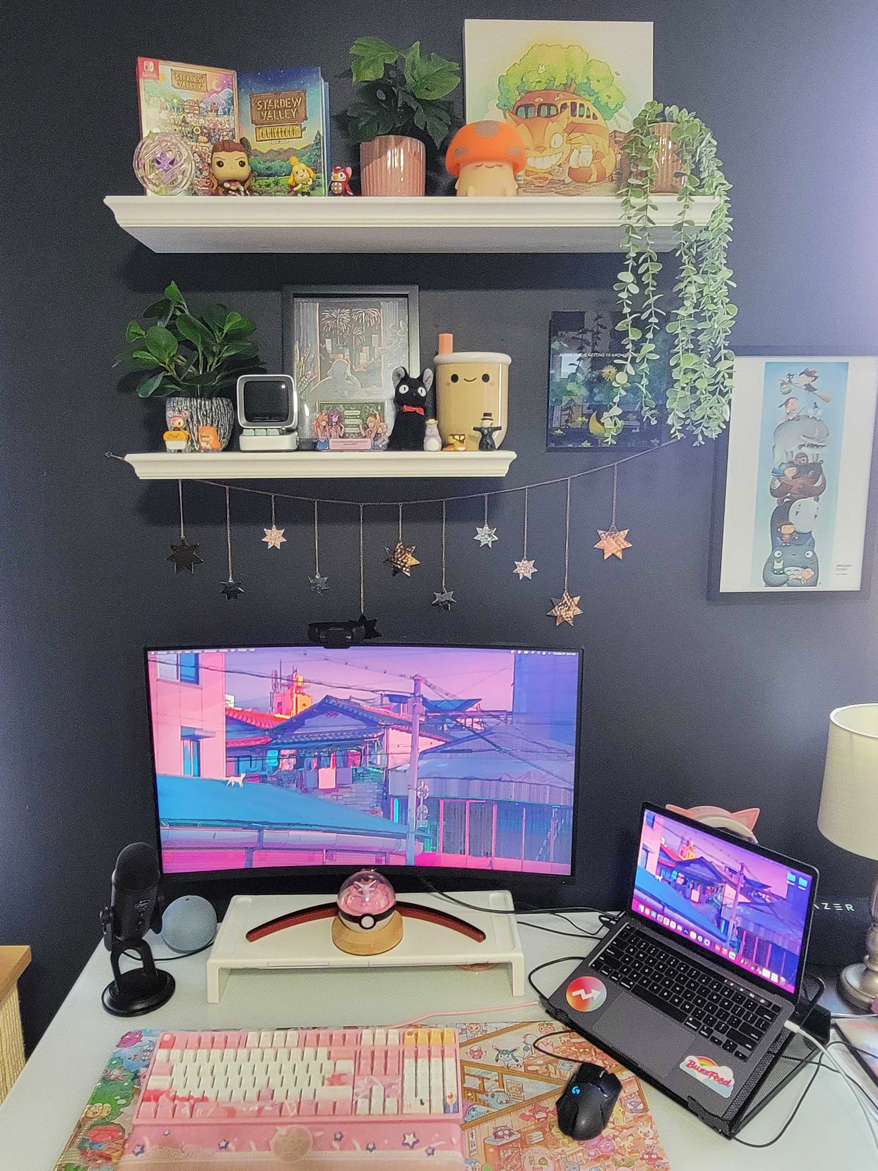 buzzfeed editor&#x27;s setup with two asymmetric shelves above desk filled with various decor