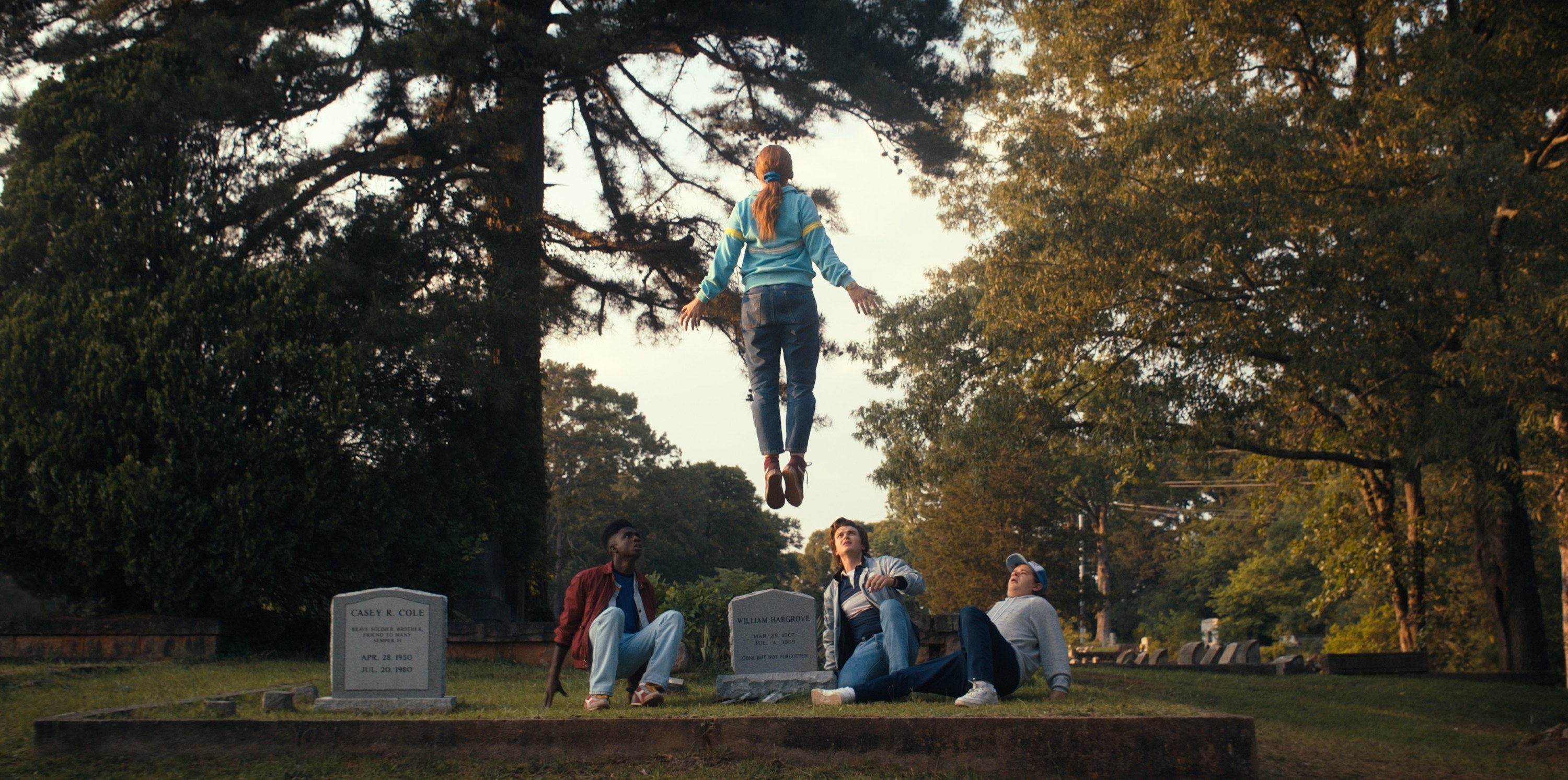 Max suspended in the air in a cemetery