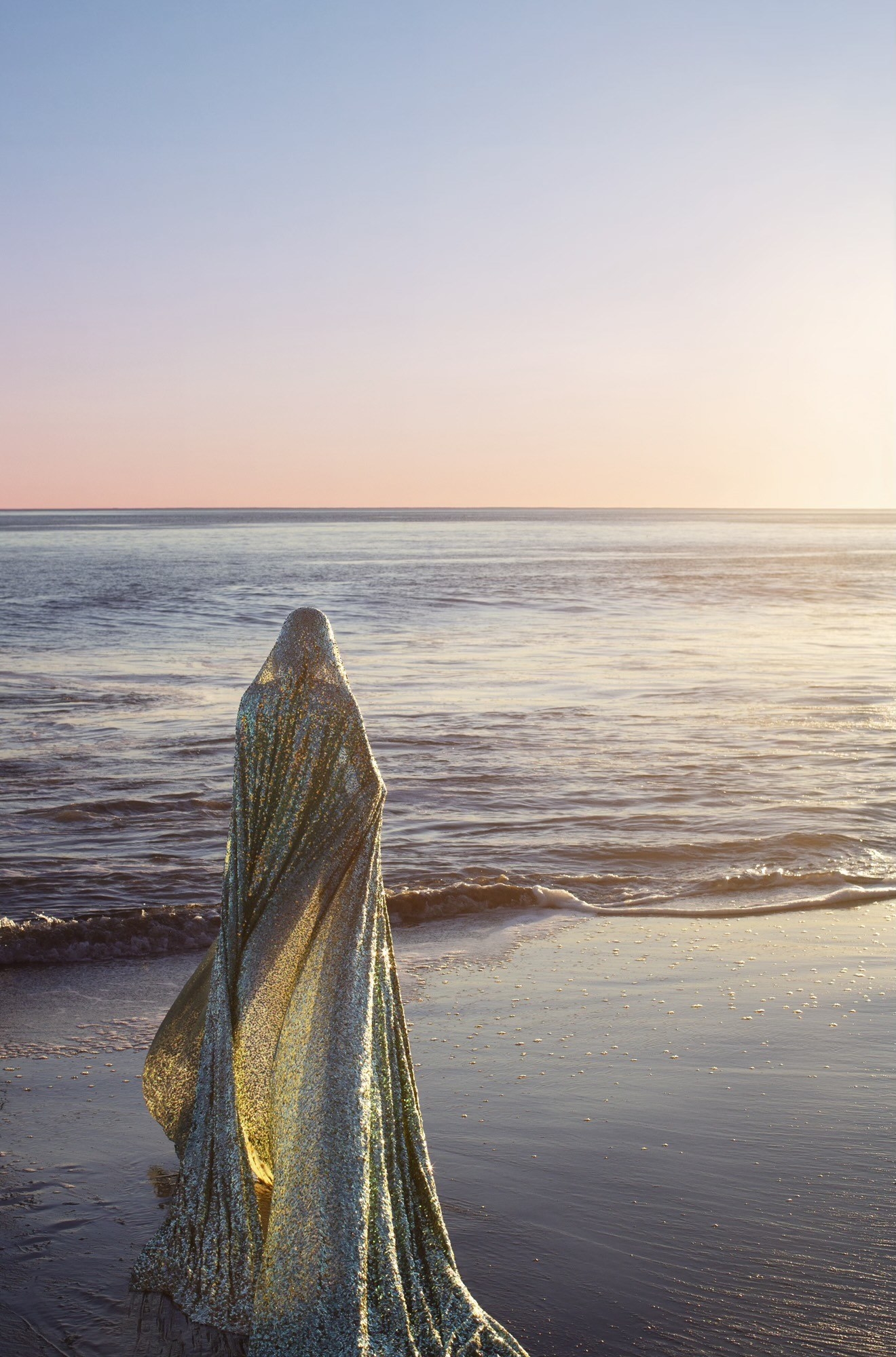 A woman walking down a beach