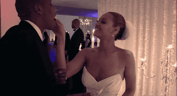 Beyoncé and Jay-Z eat cake together at their wedding