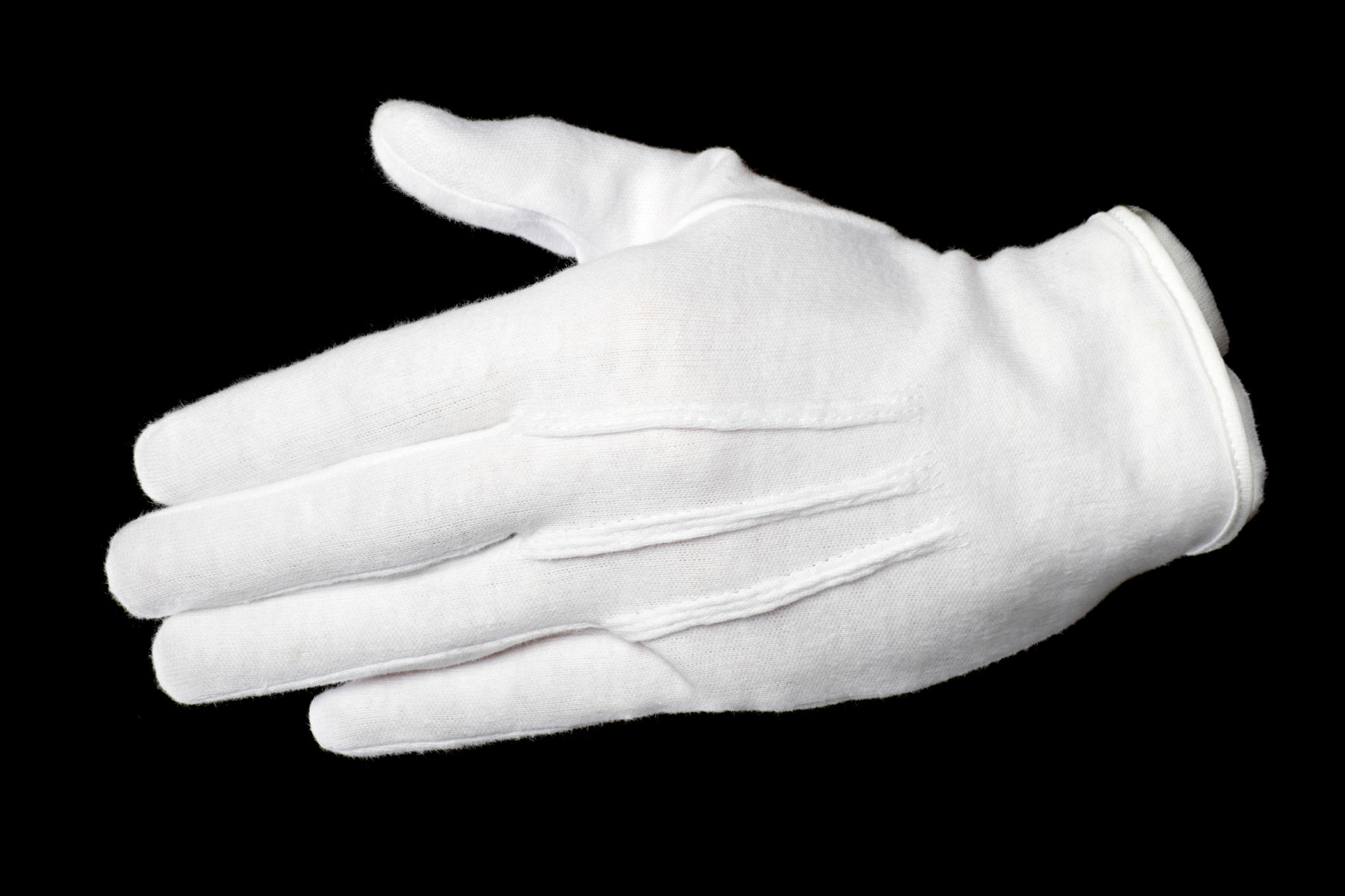 A white glove against a black background