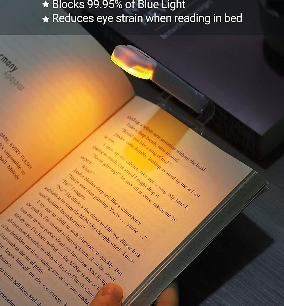 a book illuminated by the soft glow of a book light