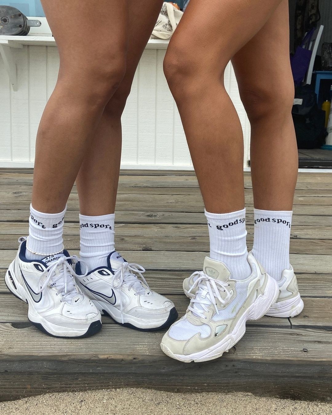 Two people wearing dad sneakers and crew socks