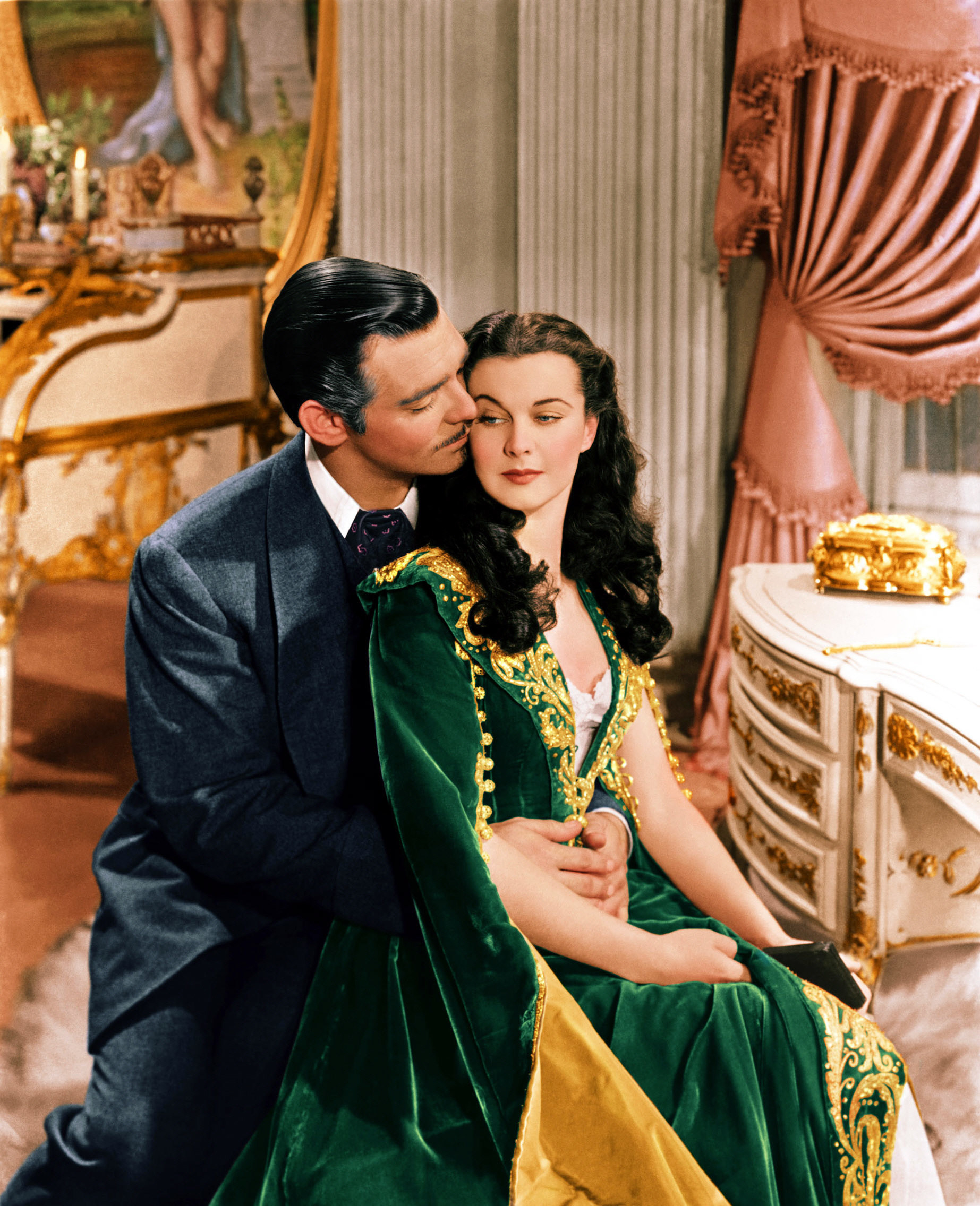 A couple from Gone With the Wind embraces, while wearing Gilded Age clothes
