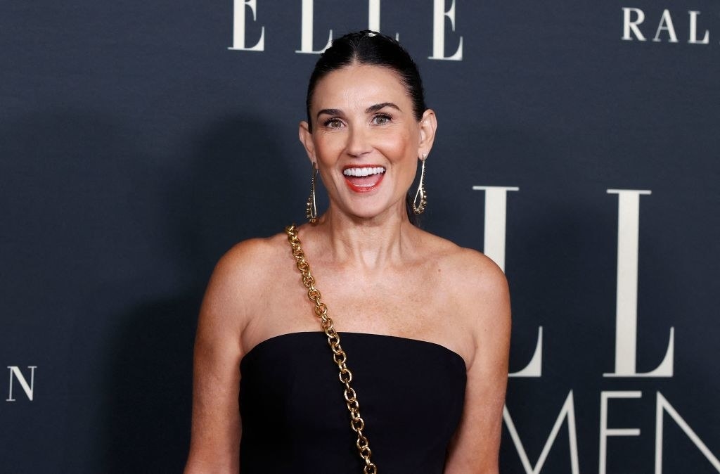 Smiling Demi Moore in a strapless top on the red carpet