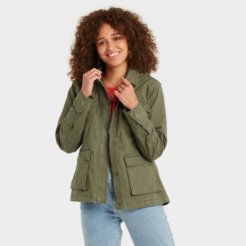 a model wearing the jacket in army green