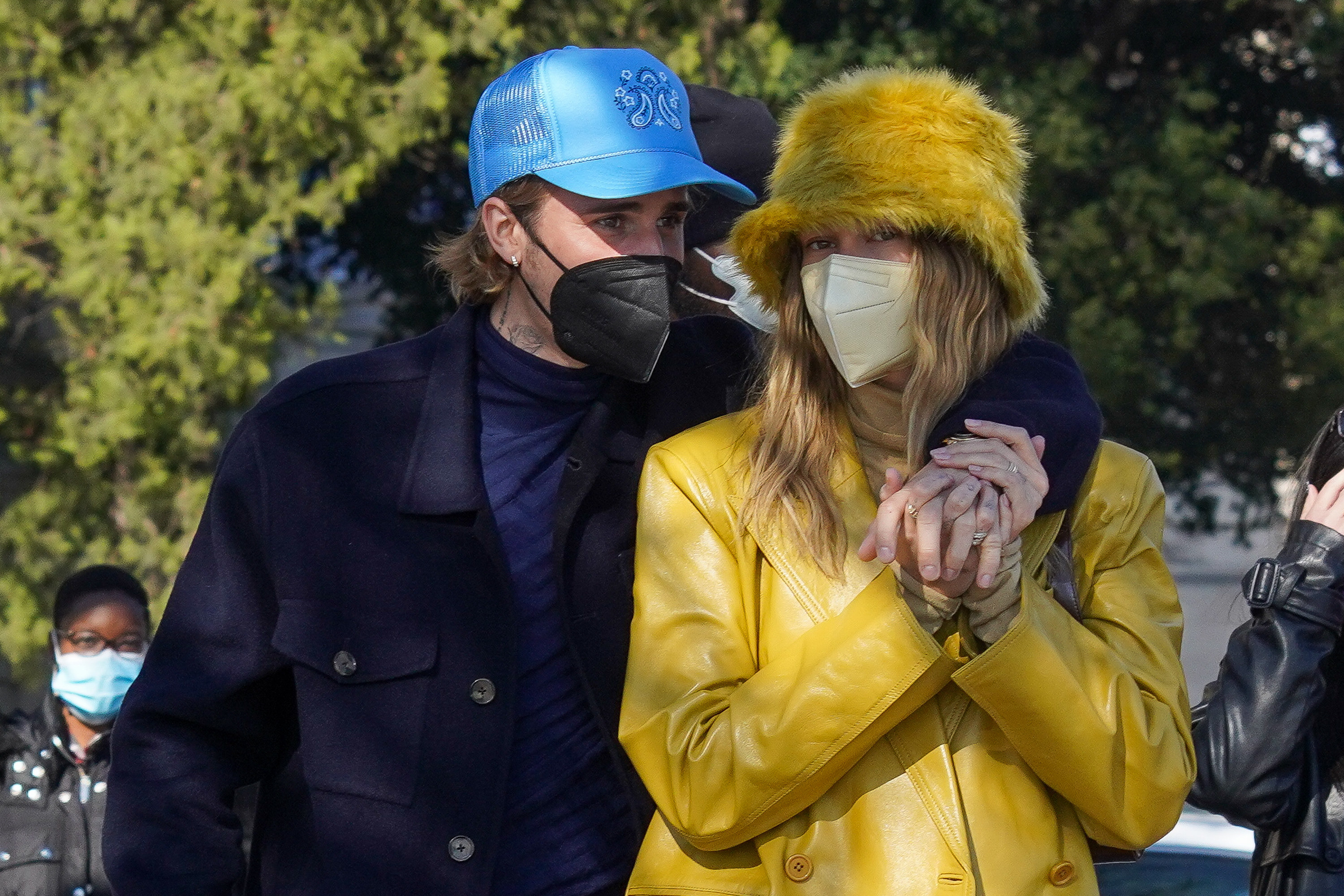 The couple wearing face masks as they walk outside with Justin&#x27;s arm over Hailey&#x27;s shoulder