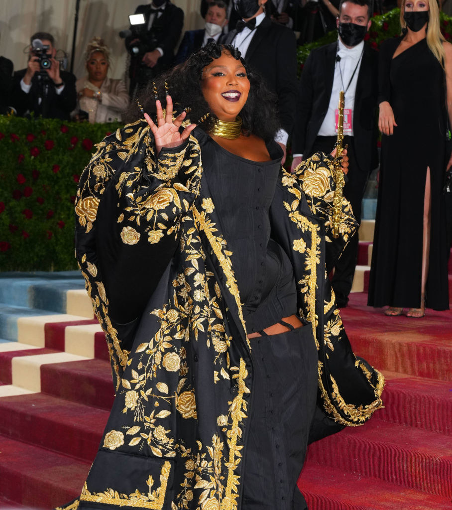 Lizzo waving from the red carpet at the Met