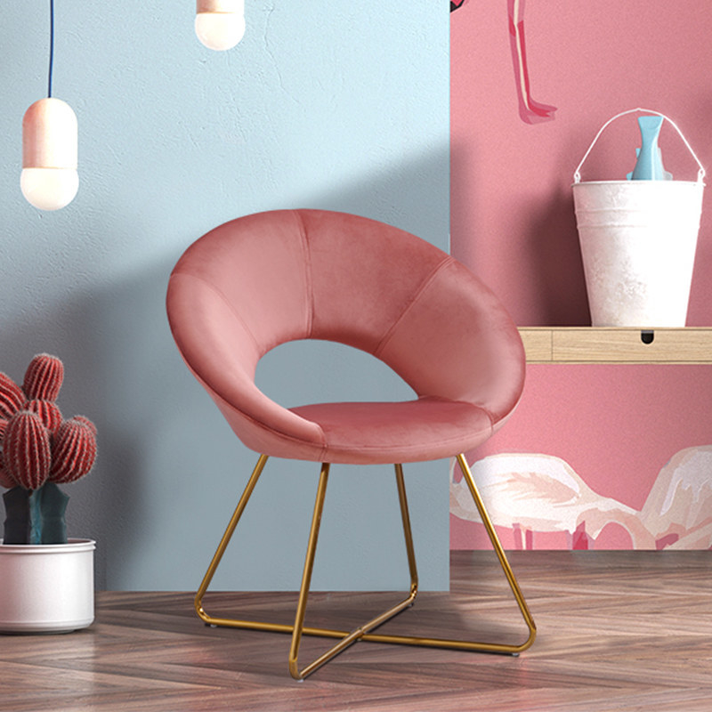 An image of a pink accent chair with metal legs