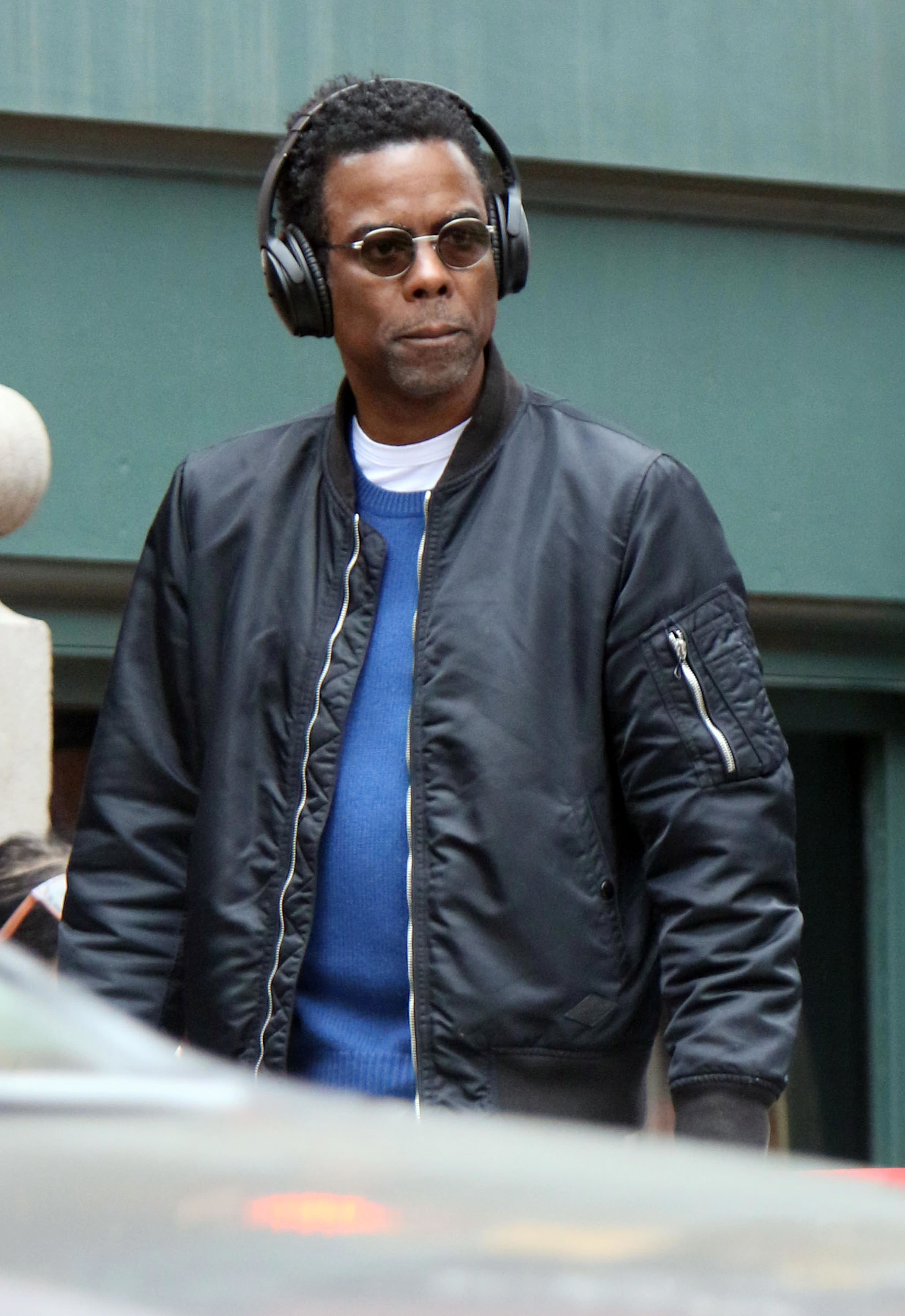 Chris walking down the street with headphones on