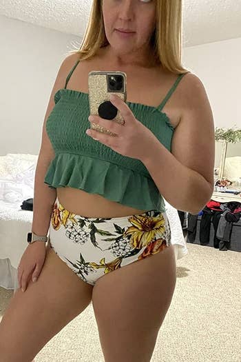a reviewer wearing the green smocked top with floral bottoms