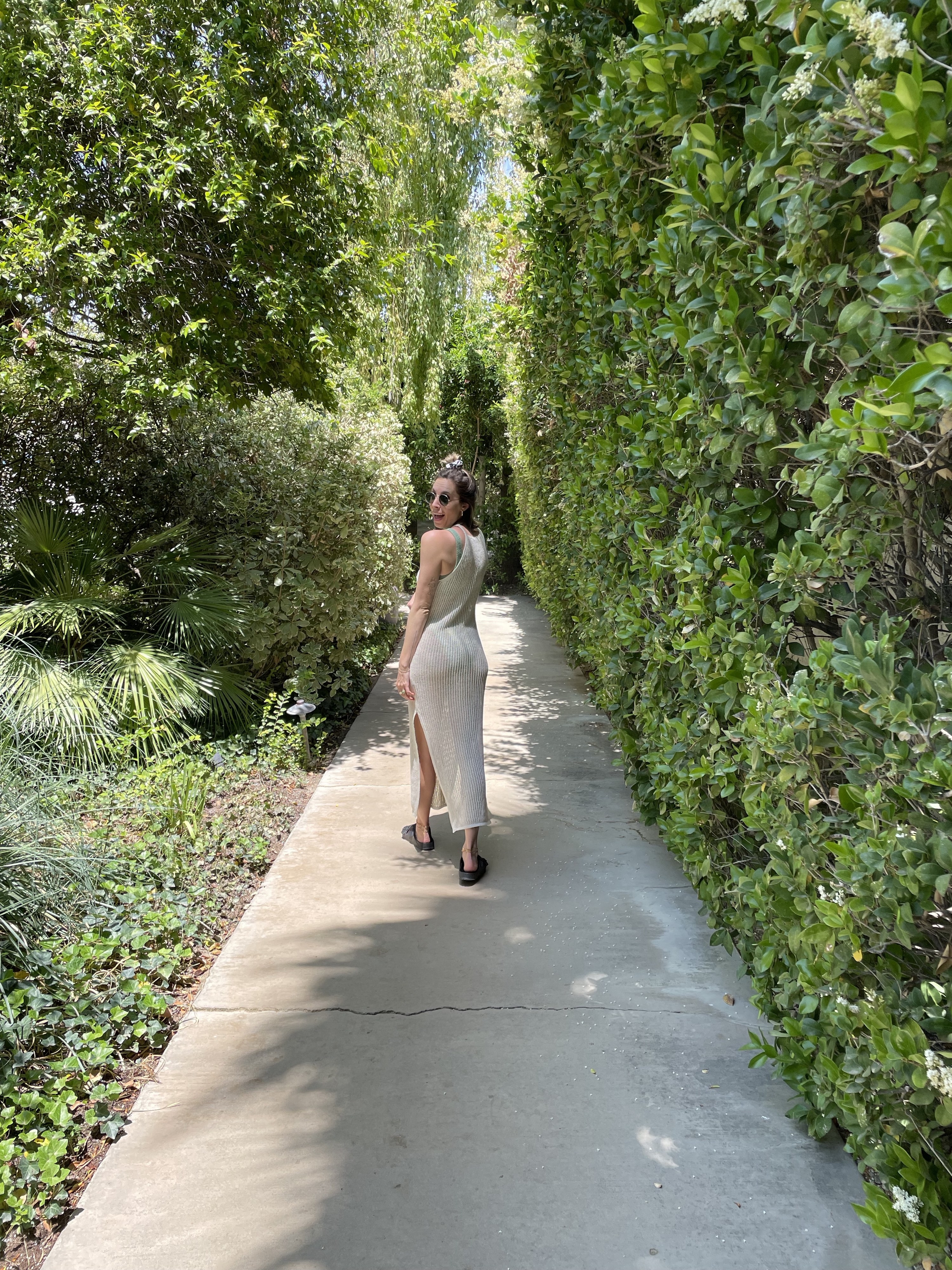 Lara, the author, walking along the concrete path that connects the hotel&#x27;s grounds