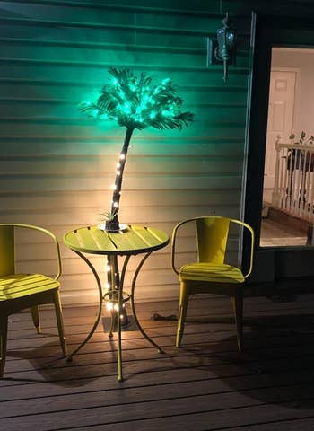 light up palm tree by some patio furniture