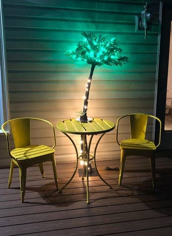 light up palm tree by some patio furniture