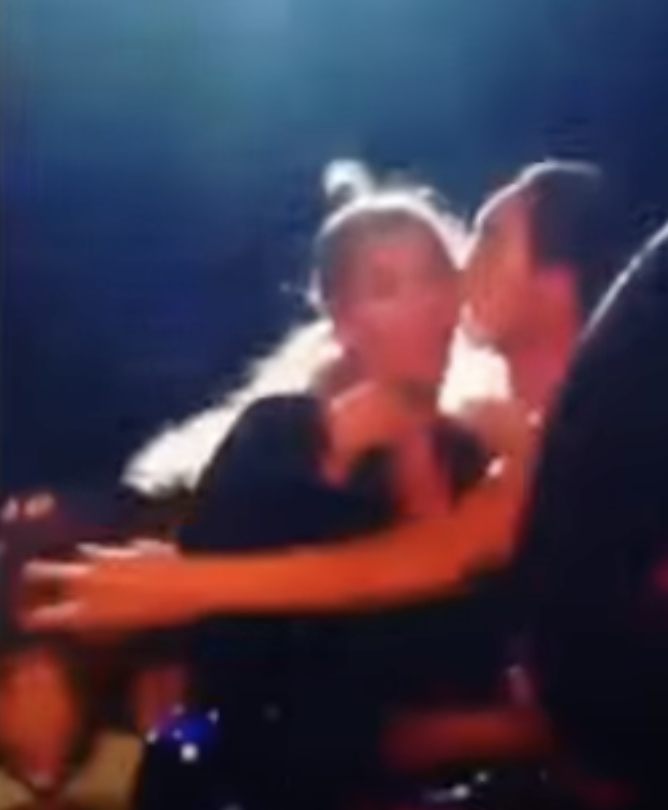 Blurry image of person embracing Beyoncé onstage