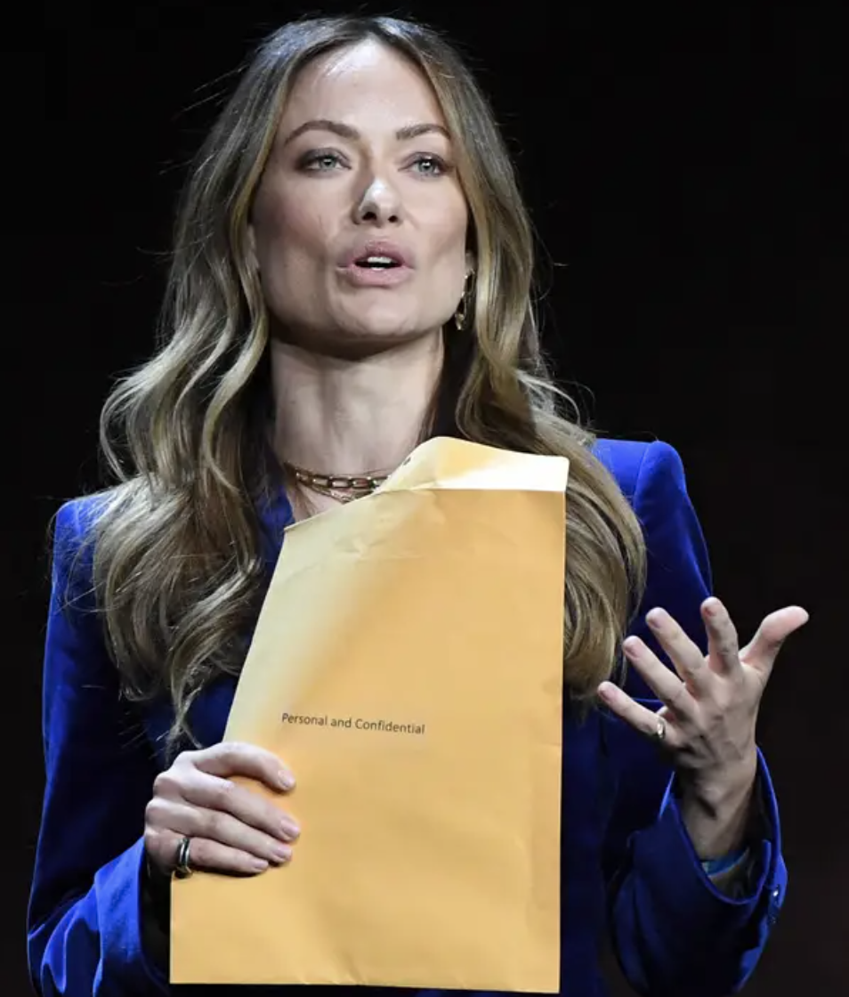 Olivia holding a large manila envelope stamped &quot;Personal and Confidential&quot;