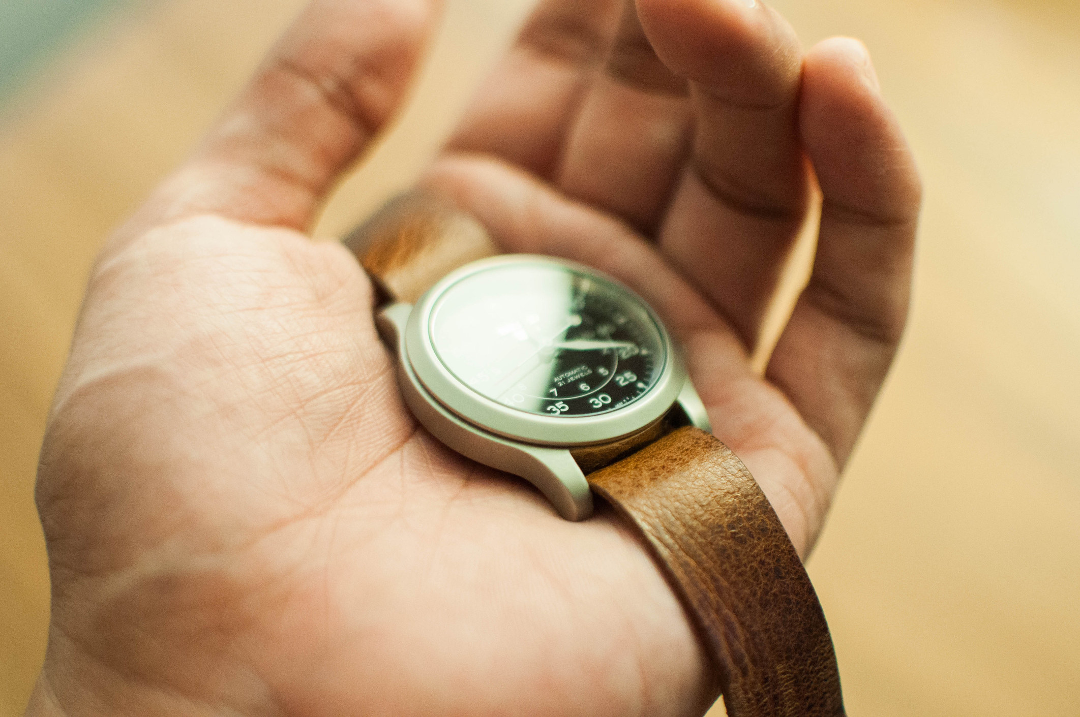 A person holding a watch in their hand