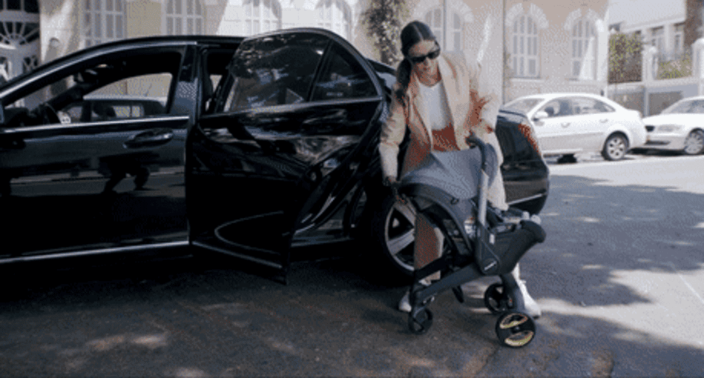 a gif of the stroller being turned into a car seat