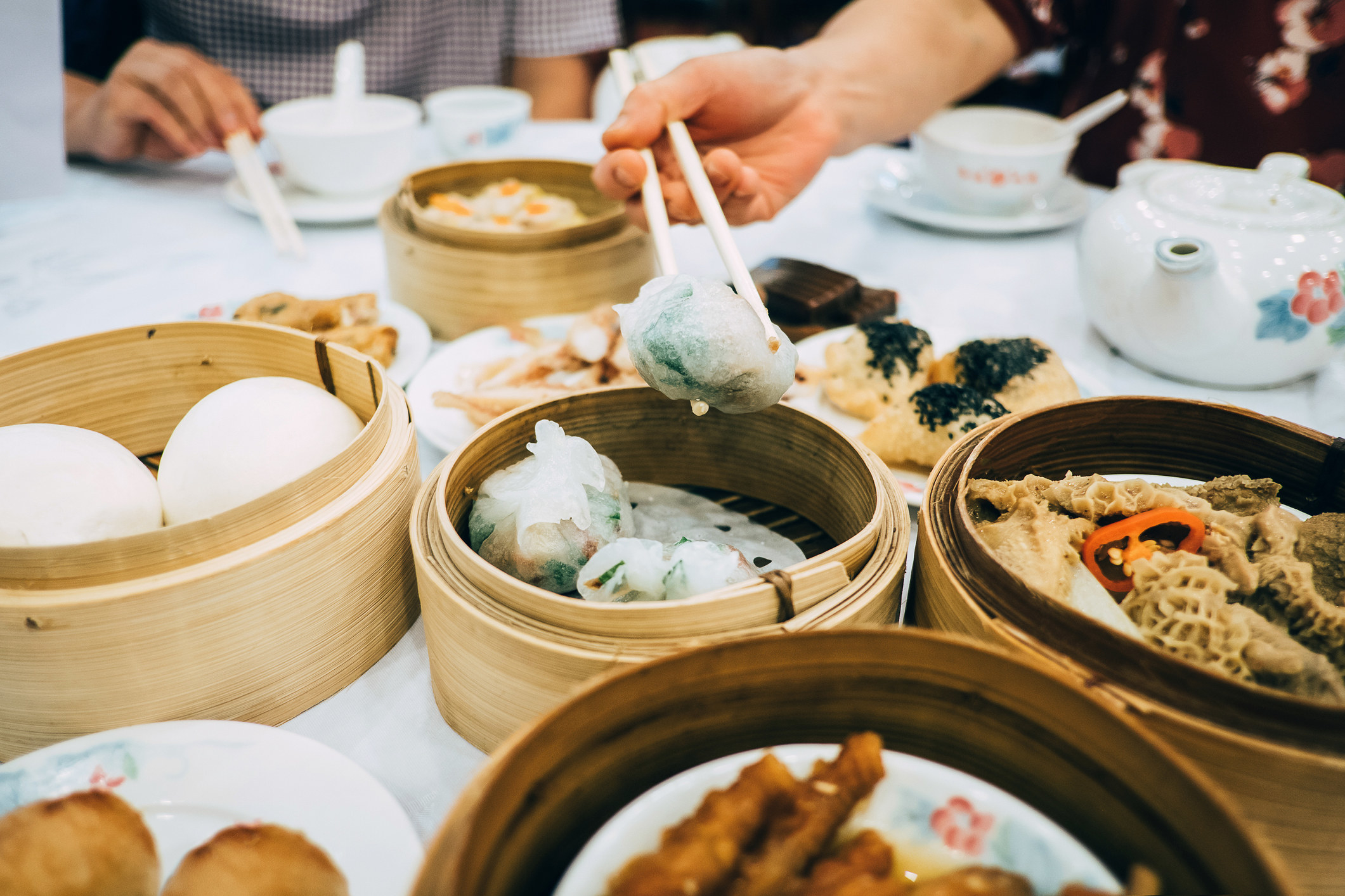 A group of people eating a dim sum meal