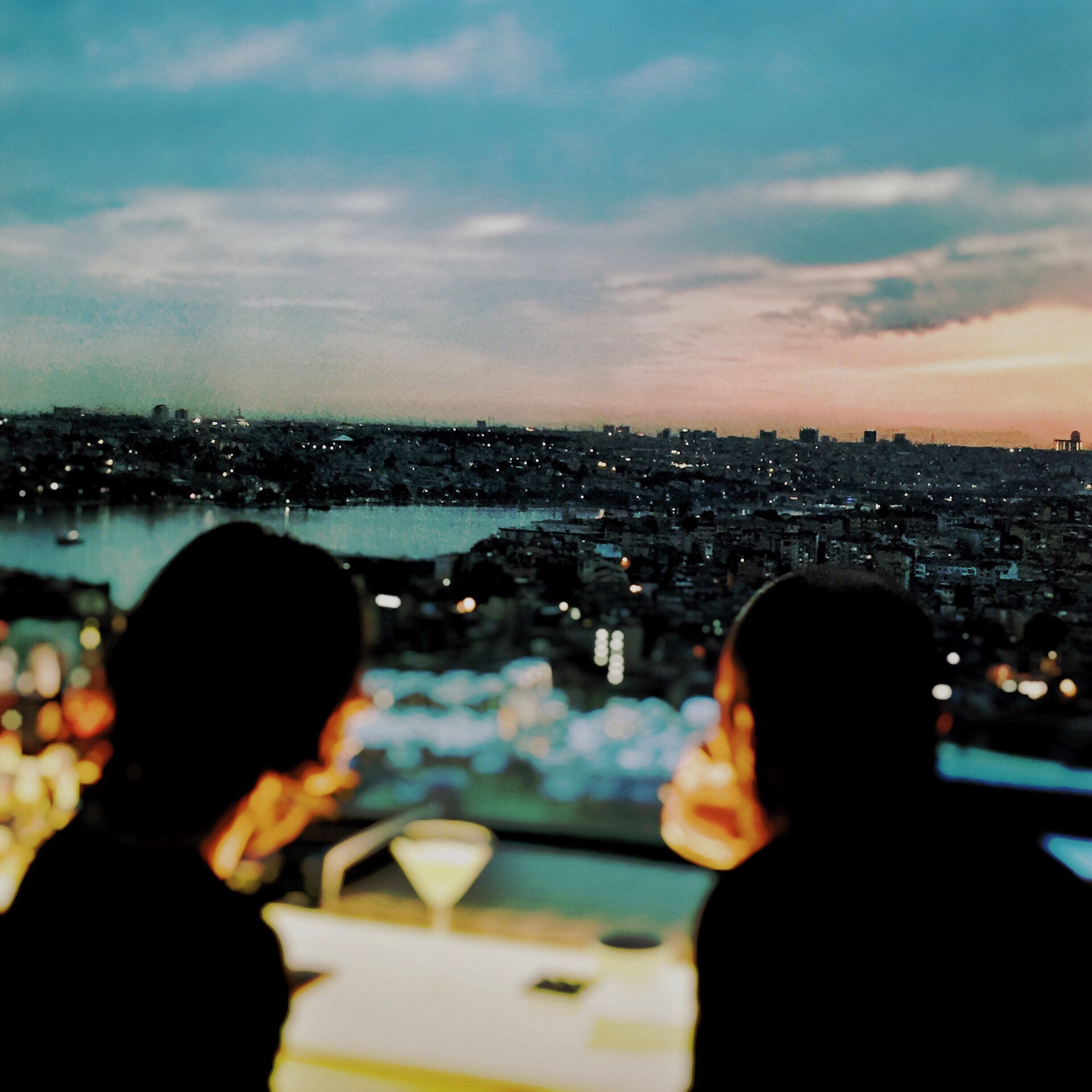 A couple sitting at a restaurant with a view of Istanbul