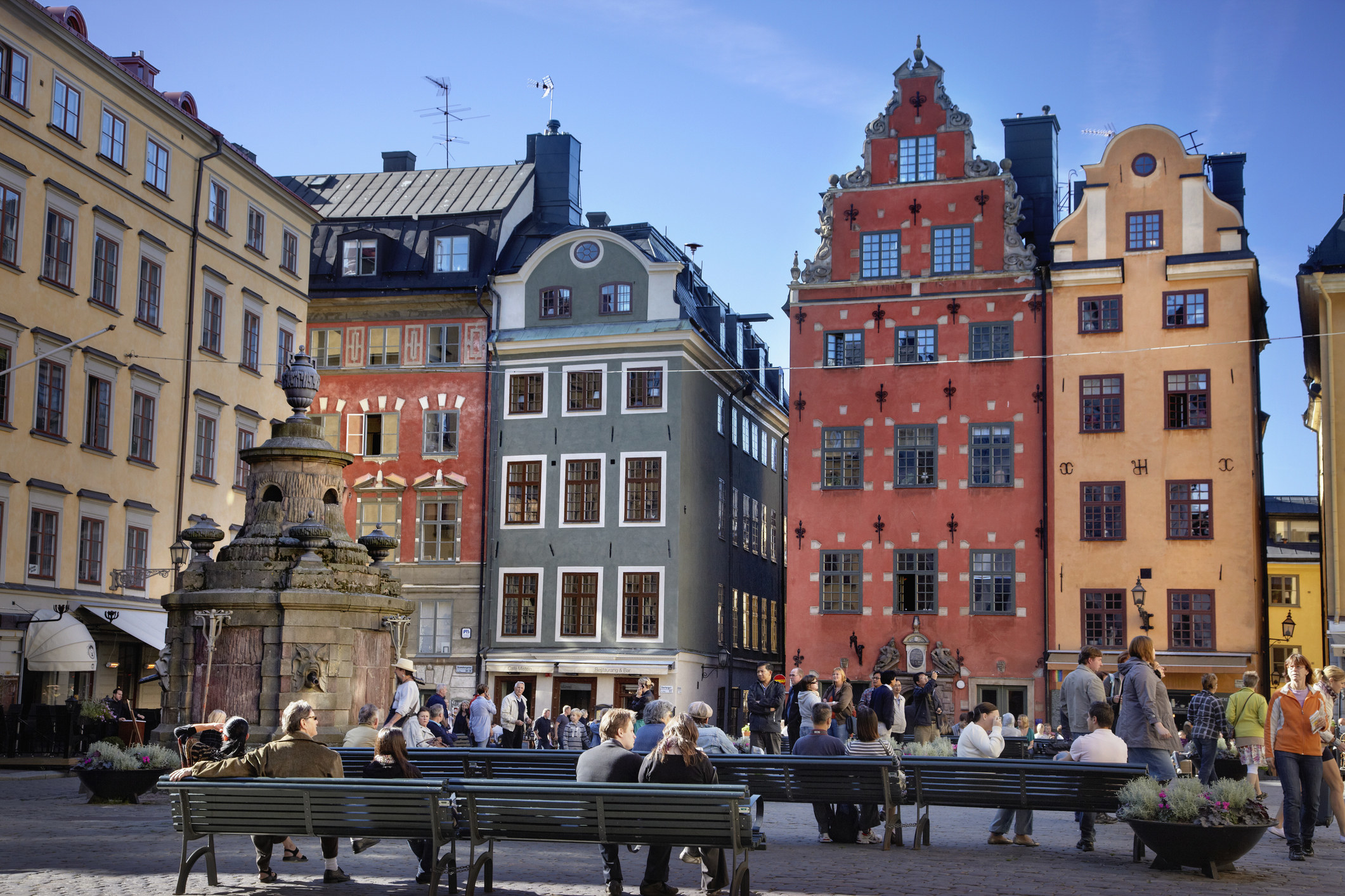 People sitting on benches in old town square in Stockholm