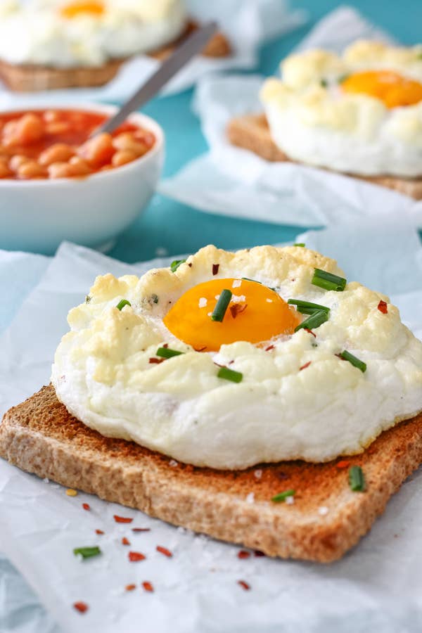 A fluffy white cooked egg sits on a piece of bread