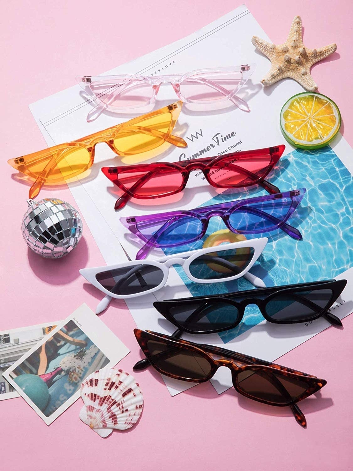 All the pairs of sunglasses laid out and surrounded by polaroids and accessories