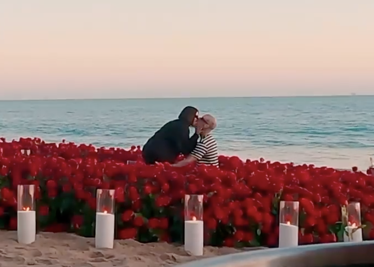 Travis and Kourtney kissing after the proposal on the beach
