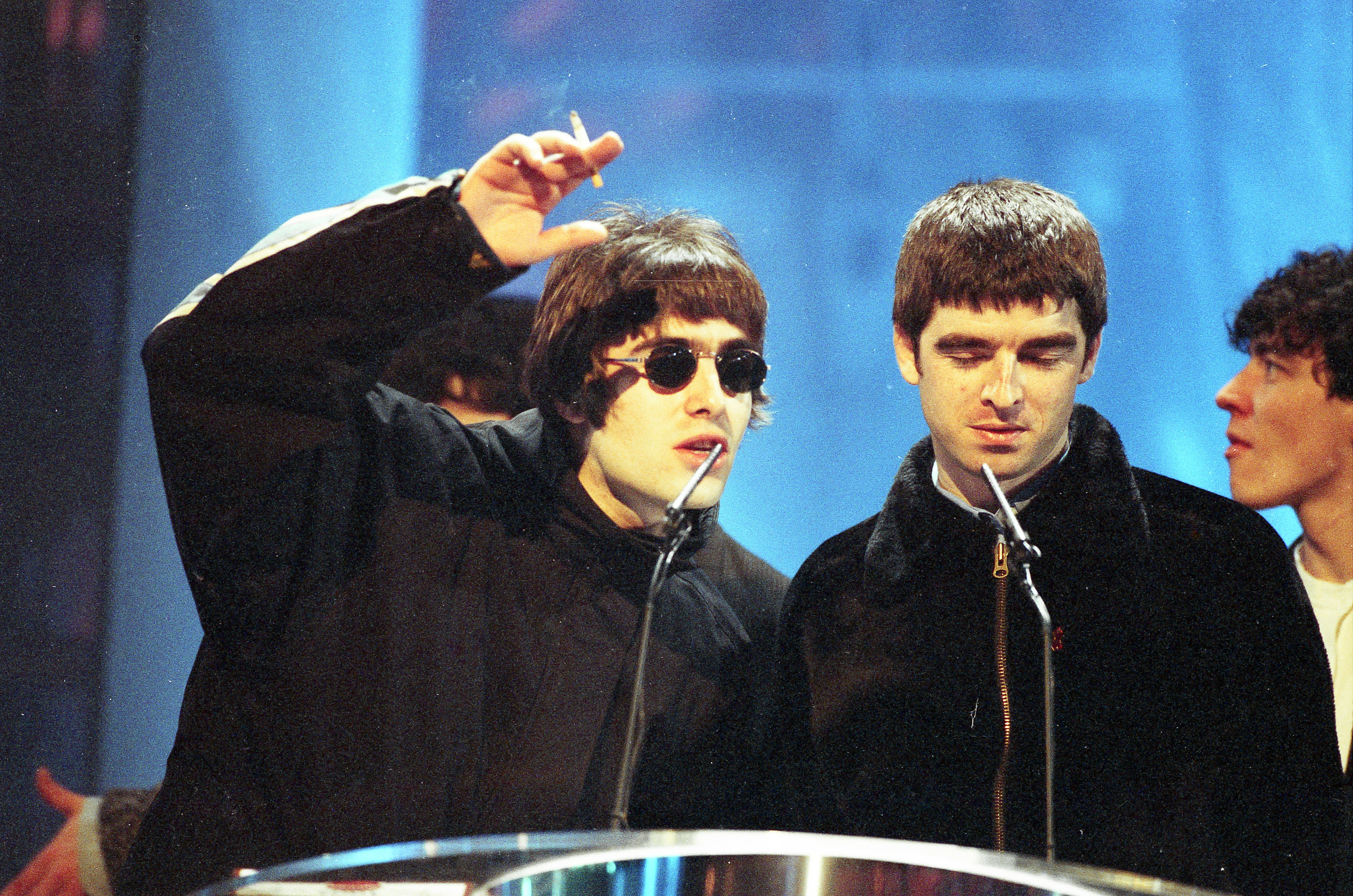Oasis accepting an award on stage