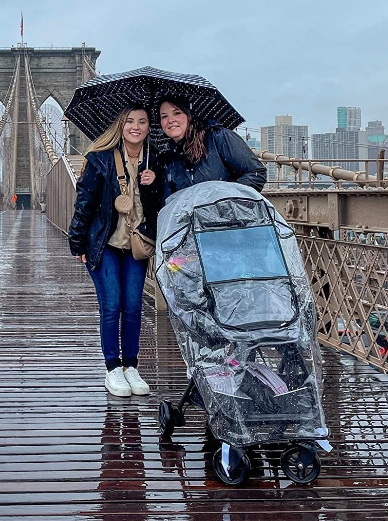 Reviewer&#x27;s photo showing the stroller cover being used in the rain