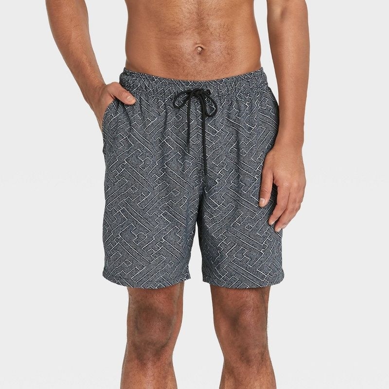 Model wearing gray swim trunks