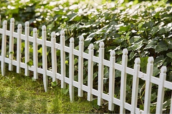 the mini picket fence around a garden