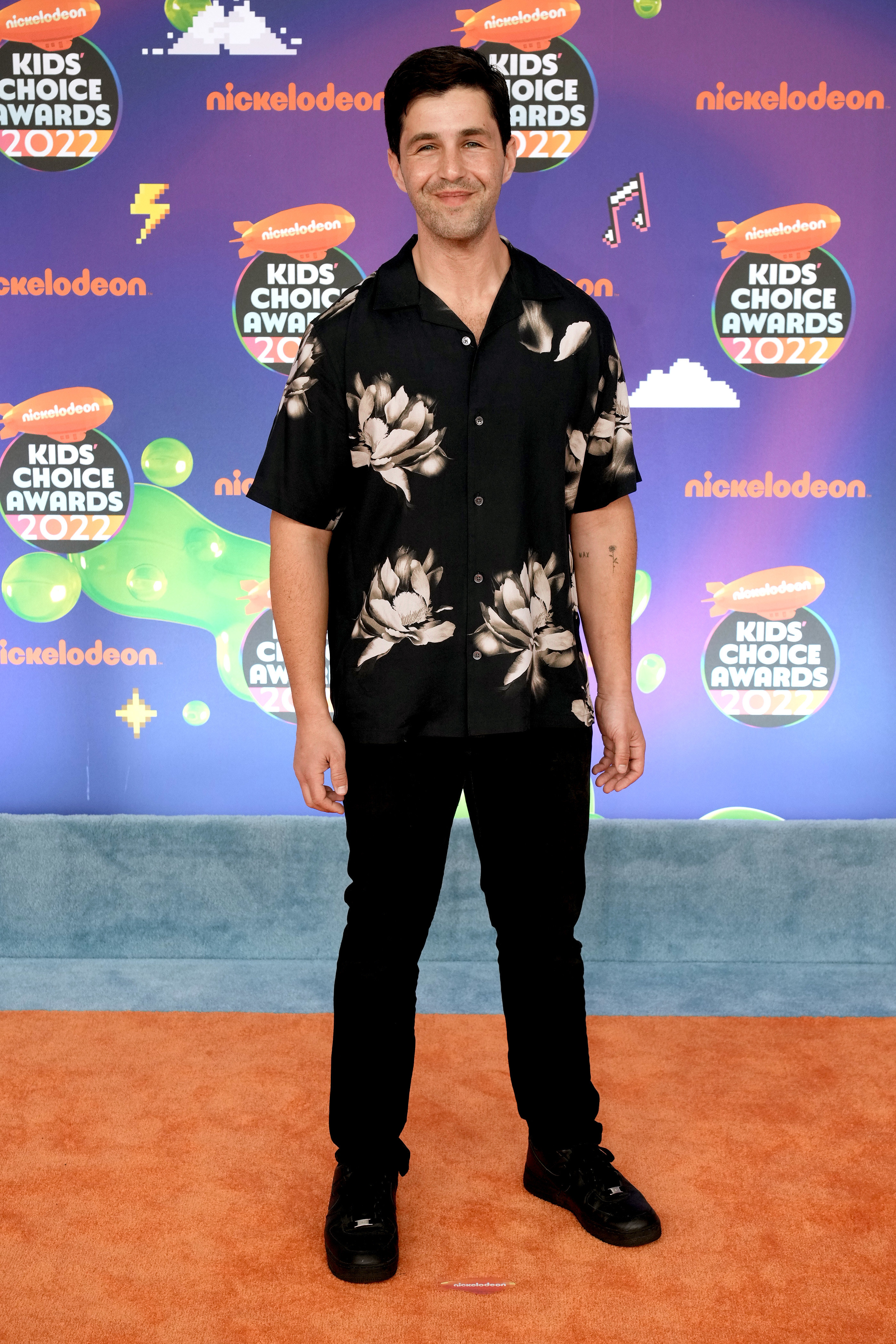 Josh in a short-sleeved flower-pattern shirt