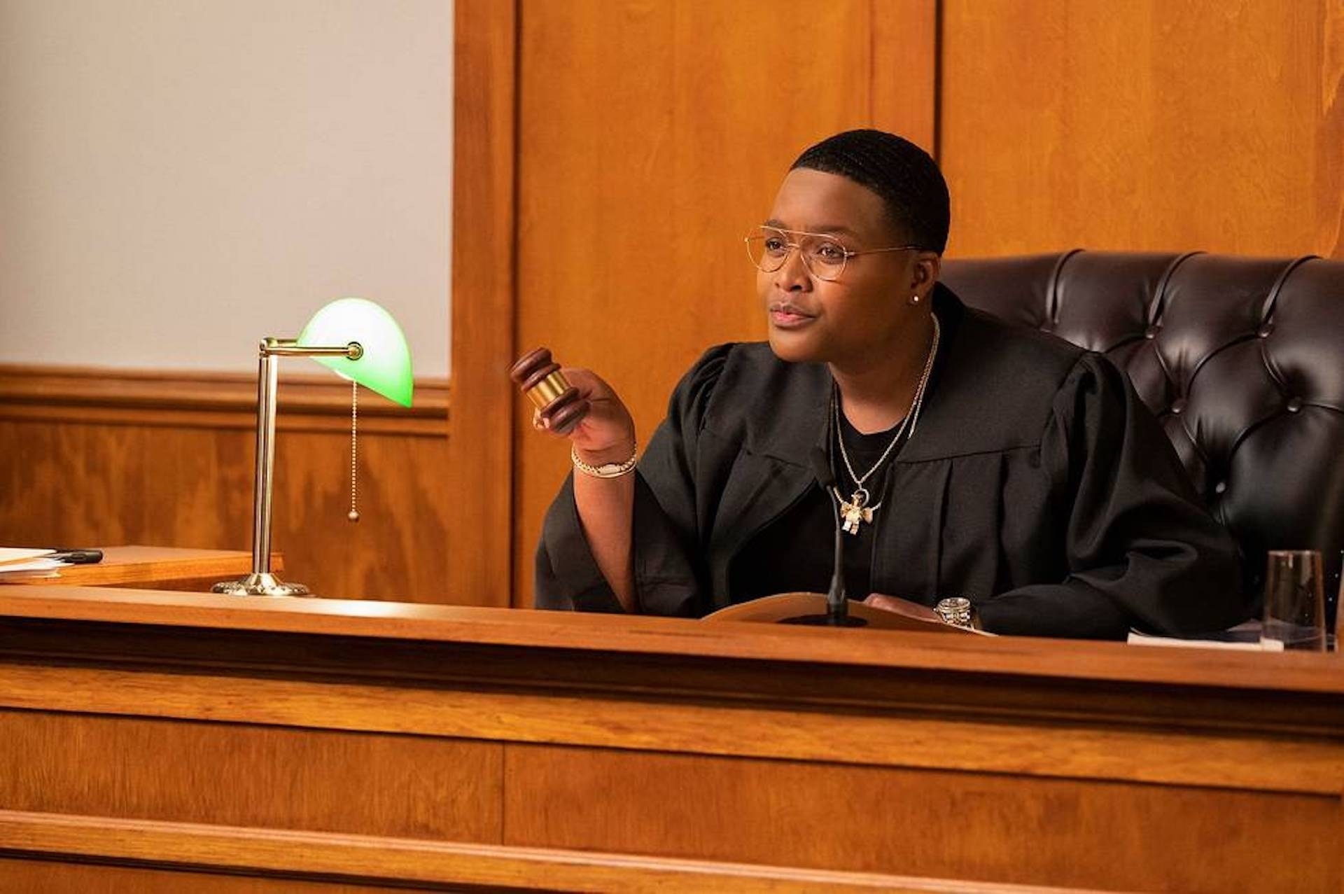 Sam Jay in a courtroom in a judges chair in Pause with Sam Jay