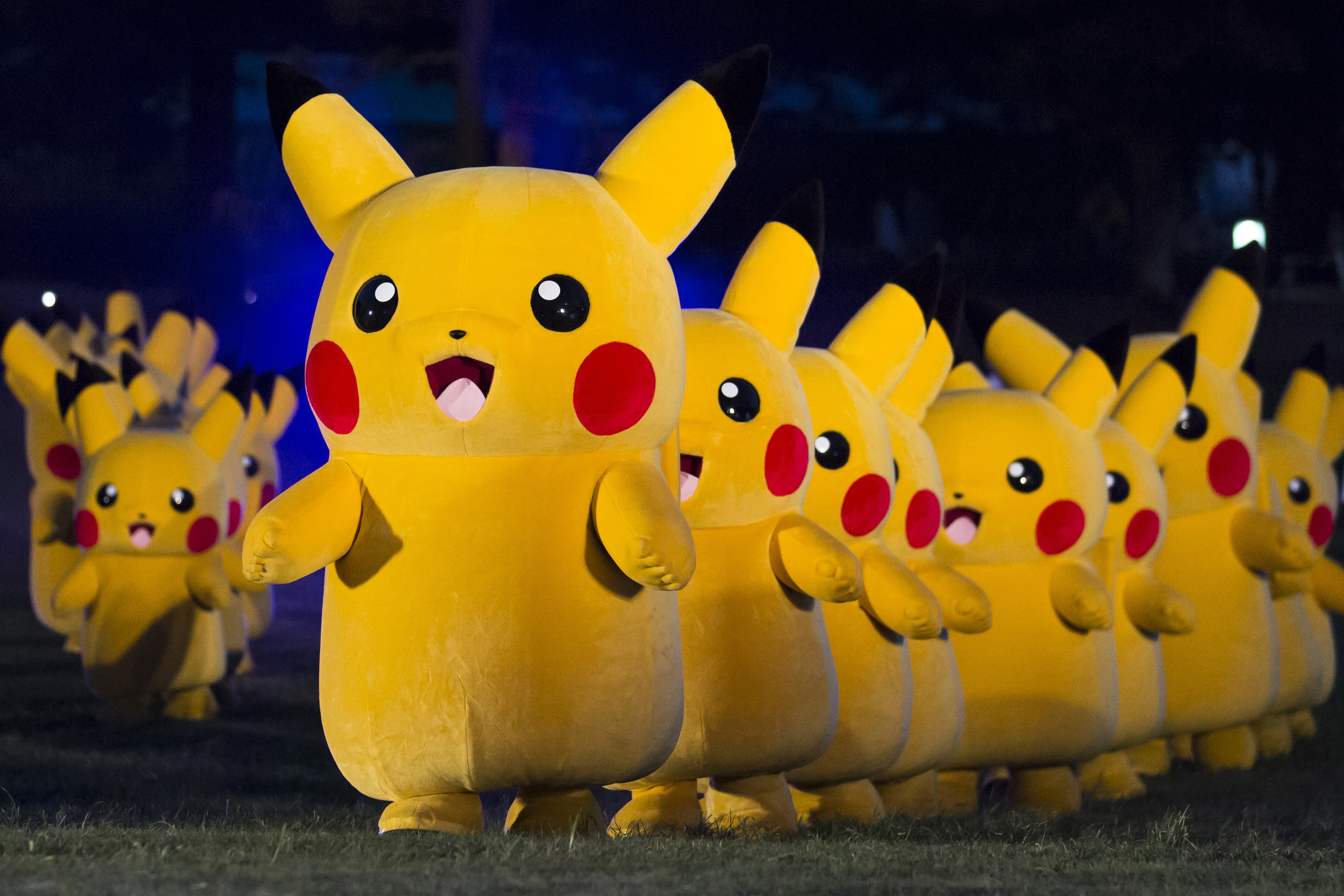 YOKOHAMA, JAPAN - AUGUST 08: Performers dressed as Pikachu, a character from the Pokémon media franchise managed by The Pokémon Company, march during the Pikachu Outbreak event at night on August 8, 2019 in Yokohama, Japan.