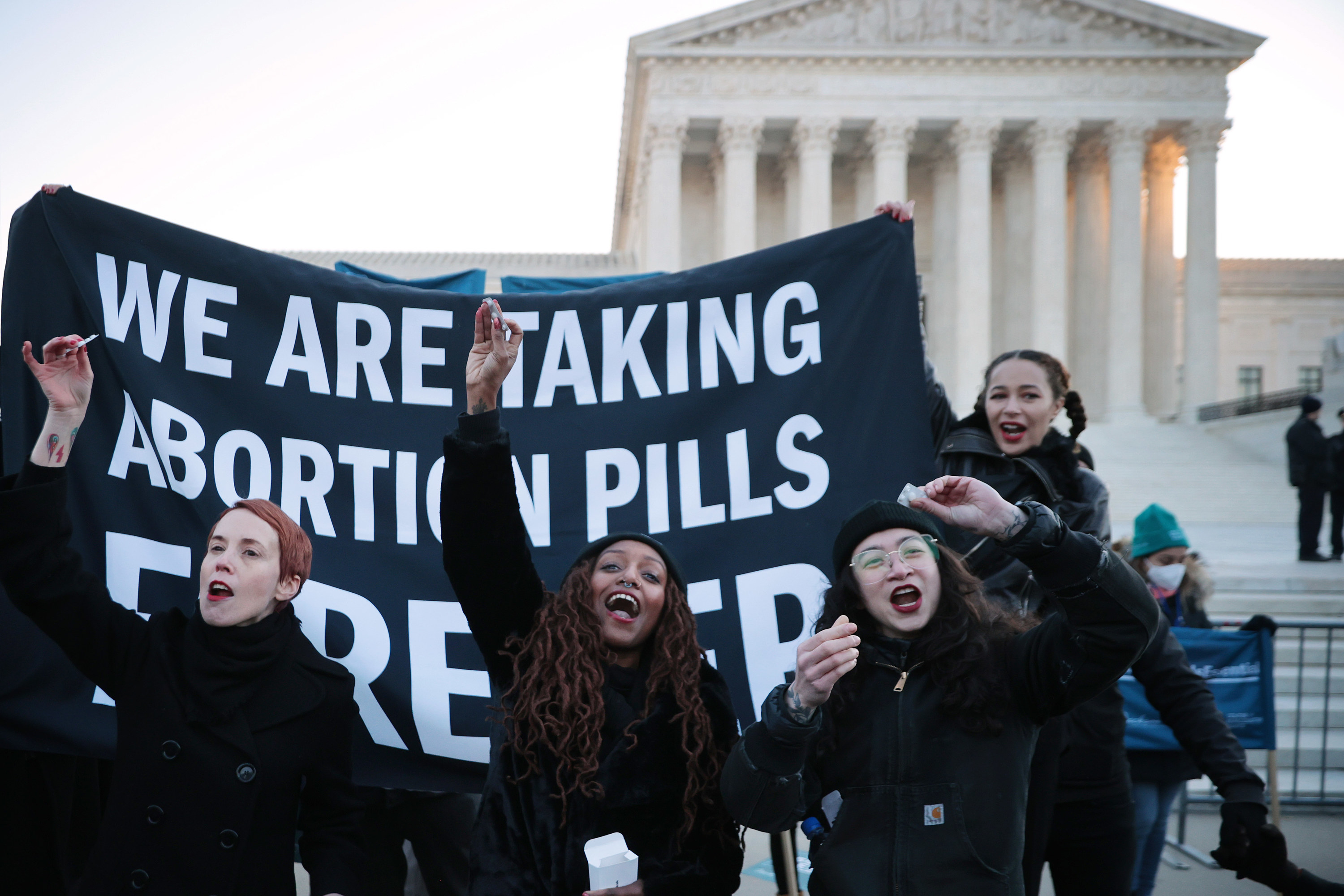 An image of protestors with a sign saying &quot;We are taking abortion pills forever&quot;